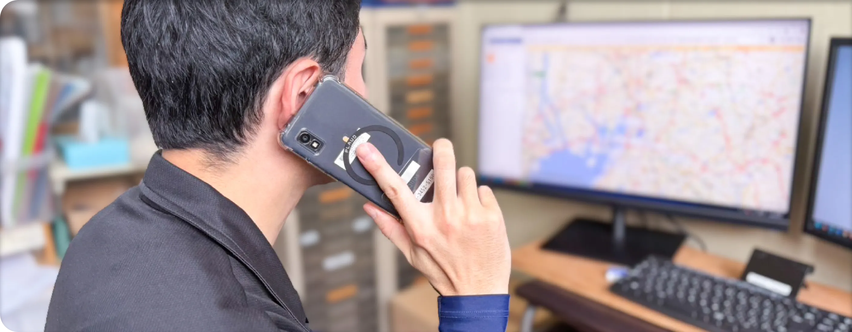 配送ルートを確認しながら電話対応する吉田さん